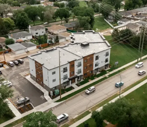 Winnipeg apartment for rent - A large apartment building with a parking lot in front.