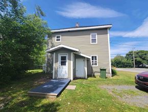 Westville apartment for rent - A small house with a grey roof and a blue door.