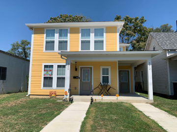 Indianapolis apartment for rent - A yellow house with a grey door and windows.
