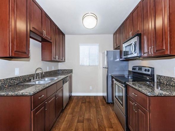 Palm Springs apartment for rent - a kitchen with wooden cabinets and stainless steel appliances