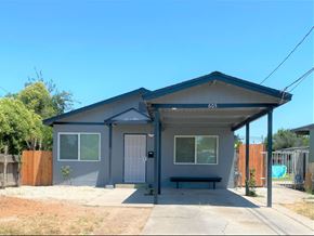 Merced house for rent - A house with a grey exterior and a covered patio area.