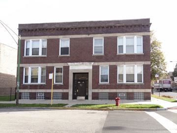 Chicago apartment for rent - a brick building with a red fire hydrant in front of it