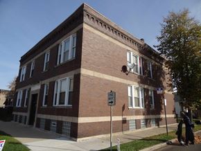 Chicago apartment for rent - a brick building with a street sign in front of it