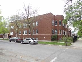 Chicago apartment for rent - a large brick building with cars parked in front of it