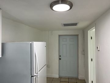 Fort Myers apartment for rent - A white refrigerator in a kitchen with a white door.