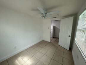 Fort Myers apartment for rent - A room with a ceiling fan and tiled floor.