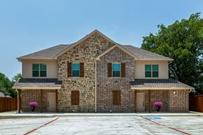 Krum apartment for rent - an empty parking lot in front of a brick house