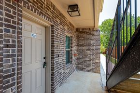 Krum apartment for rent - the entrance to a brick building with a white door