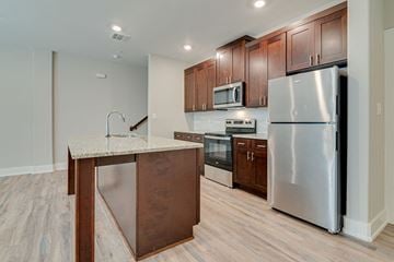Krum apartment for rent - a kitchen with stainless steel appliances and a marble counter top