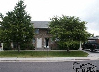 Orem apartment for rent - A house with a tree in front of it.