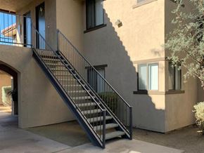 Indio apartment for rent - a stairwell with a metal railing on the side of a building