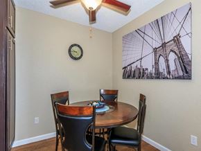 Palm Springs apartment for rent - a dining room with a table and chairs and a clock on the wall