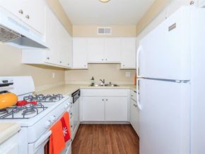 Palm Springs apartment for rent - a white kitchen with a stove and a refrigerator