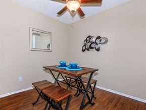 Palm Springs apartment for rent - a dining room with a table and chairs and a ceiling fan