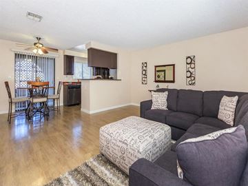 Indio apartment for rent - a living room and kitchen with a couch and a