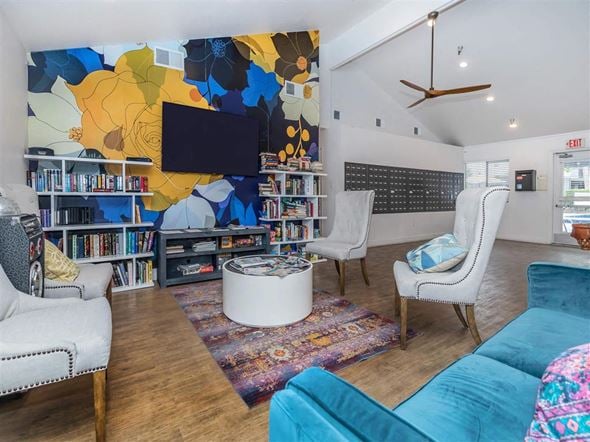 Hemet apartment for rent - a living room with a blue couch and chairs and a television