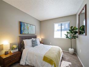 Hemet apartment for rent - a bedroom with a large bed and a window