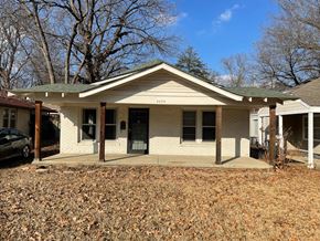 Memphis house for rent - a white brick house with a porch and a car in front of it
