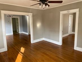 Memphis house for rent - an empty living room with wood floors and a ceiling fan