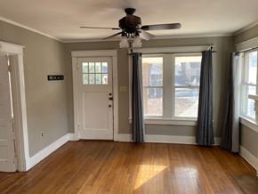 Memphis house for rent - an empty living room with a ceiling fan and windows