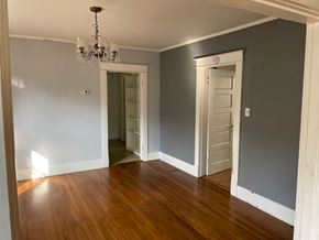 Memphis house for rent - a living room with blue walls and a wooden floor and a closet with two doors