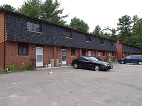 Gravenhurst apartment for rent - A black car is parked in front of a brick building.