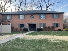 Dayton house for rent - A red brick house with a black door and windows.