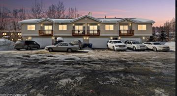 Anchorage apartment for rent - a house with cars parked in front of it