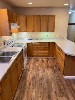 Soldotna house for rent - A kitchen with wooden cabinets and a white countertop.