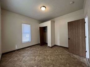 Fort Collins apartment for rent - an empty living room with a door and a window