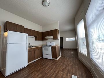 Fort Collins apartment for rent - an empty kitchen with white appliances and wooden floors