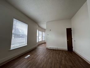 Fort Collins apartment for rent - an empty living room with wood flooring and a large window
