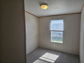 Shawnee house for rent - A room with a window and a view of a building outside.