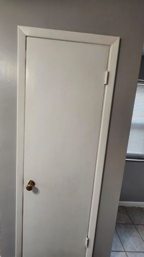 Cincinnati apartment for rent - A white door with a brass knob is set in a grey wall.
