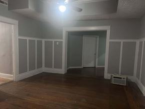 Cincinnati apartment for rent - A room with wooden floors and white trimmed walls.