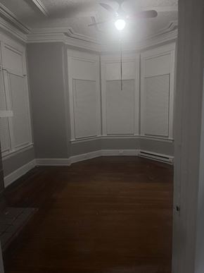 Cincinnati apartment for rent - A room with wooden floors and white walls.