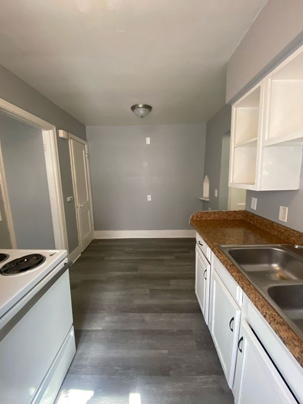 Cincinnati apartment for rent - A kitchen with a stove top oven and a sink.