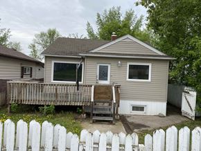 Prince Albert house for rent - a house with a deck and a white fence