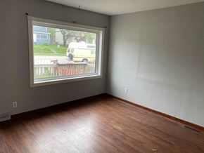 Prince Albert house for rent - a living room with a large window and wooden floors