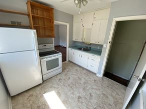 Prince Albert house for rent - an empty kitchen with white appliances and white cabinets