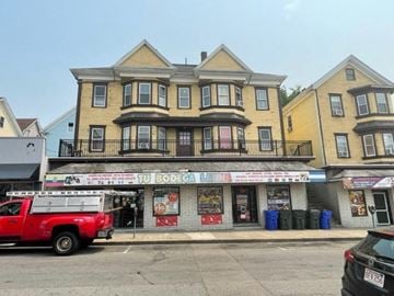 Fall River apartment for rent - a fire truck parked in front of a store on a city street