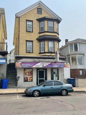 Fall River apartment for rent - a blue car parked in front of a tall house