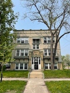 Fargo apartment for rent - an old building with a tree in front of it