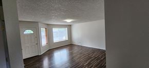 Longview apartment for rent - an empty living room with wood floors and a white door
