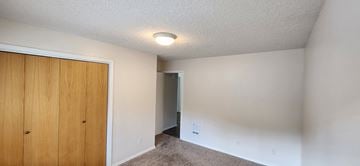 Longview apartment for rent - a bedroom with a closet and a door to a hallway