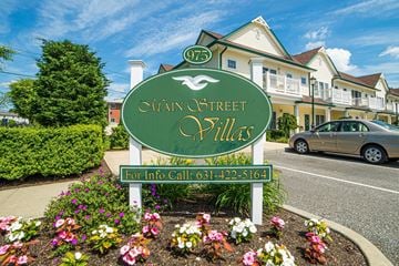 Farmingdale apartment for rent - a street sign in front of a house on the side of a road