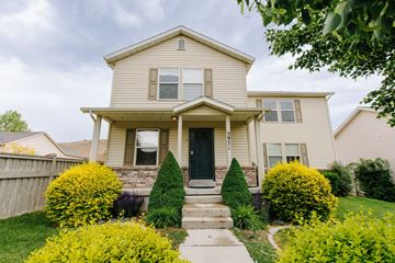 Eagle Mountain house for rent - a yellow house with a black door and a sidewalk in front of it