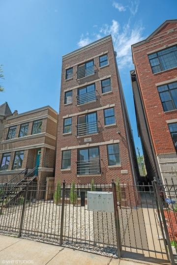 Chicago apartment for rent - a large brick building with a gate in front of it