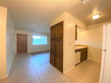Merced house for rent - a kitchen and a living room with a sink and a door