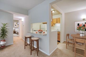 Silver Spring apartment for rent - a living room and kitchen with a table and stools